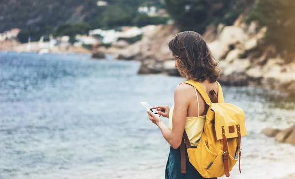 Traveler using in female hand mobile