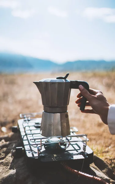 moka pot coffee outdoor, campsite morning picnic lifestyle, person cooking hot drink in nature camping, prepare breakfast, tourism vacation outside