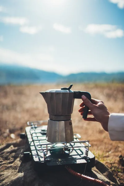 moka pot coffee outdoor, campsite morning picnic lifestyle, tourist cooking hot drink in nature camping, cooker prepare breakfast, tourism recreation outside
