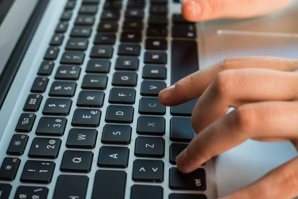 hands using the keyboard of a laptop