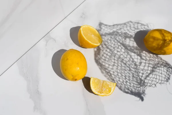lemon on a white background with a net shadow