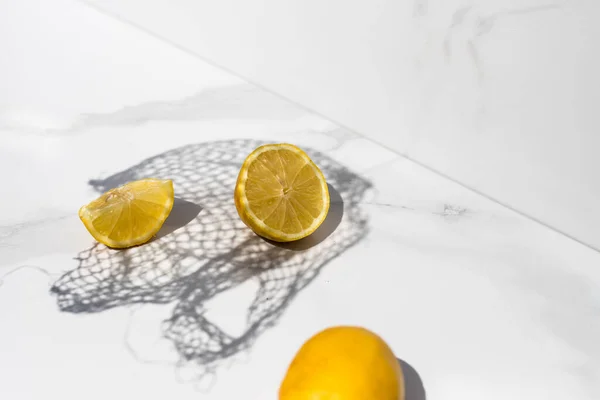 lemon on a white background with a net shadow