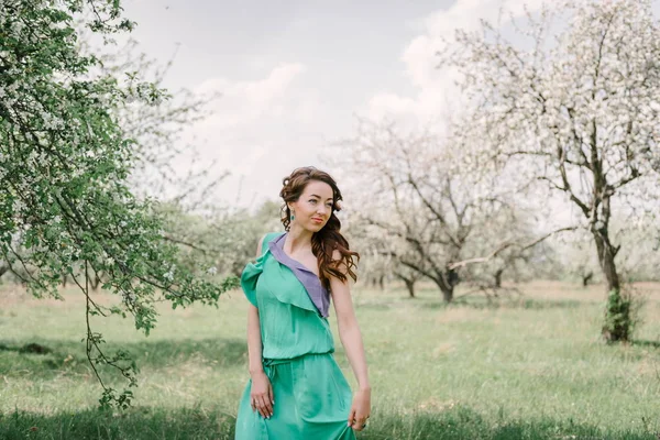 Bella ragazza di buon umore in primavera in una mela fiorita o — Foto Stock