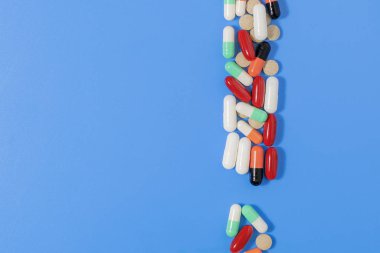 Farklı renkte ilaç içeren tablet ve kapsüllerin resmi