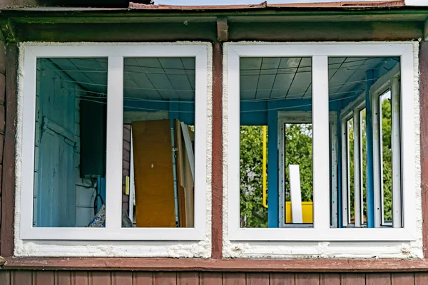 Installation of a plastic window in an old wooden house