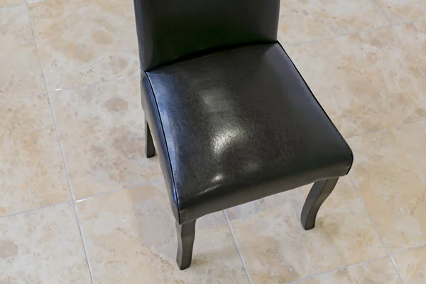 Fragment of a dark Executive chair in the office