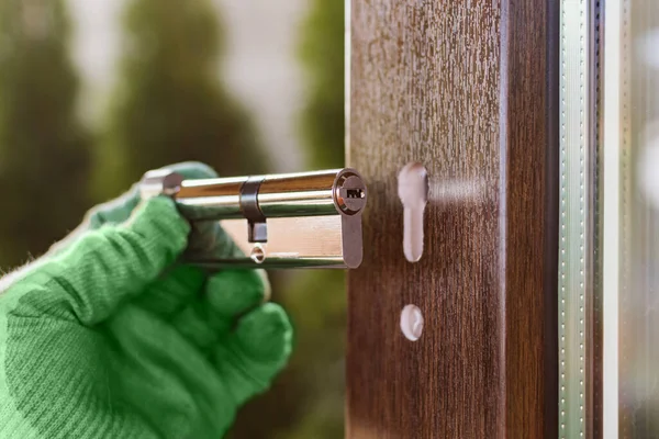 Fragment of the handle and lock of the plastic door during installation