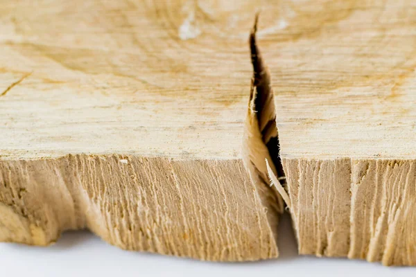 Fragment of sawn raw wood with cracks