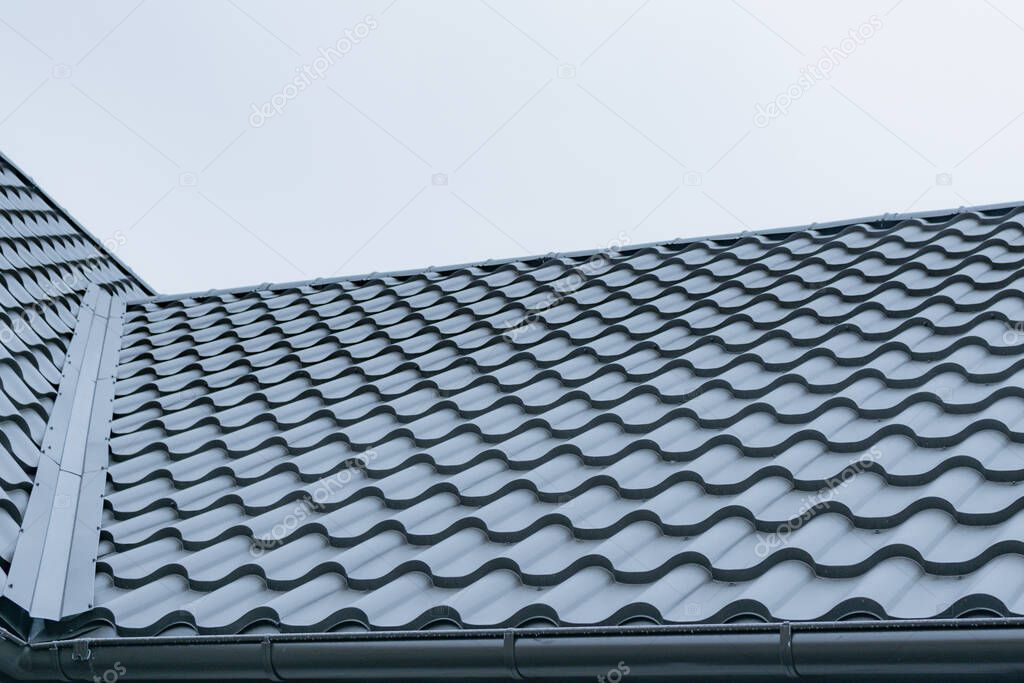 Fragment of the new roof of the house of metal profile