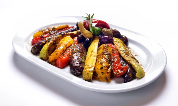 Grilled vegetables on white plate with olives — Stock Photo, Image