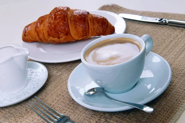 Tazza di caffè e un croissant — Foto Stock