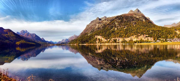 Mountain lake panorama with mountains reflection. Idyllic look.