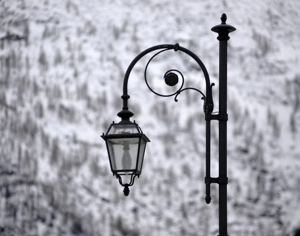 street lamp against the background of a winter landscape. Old fa