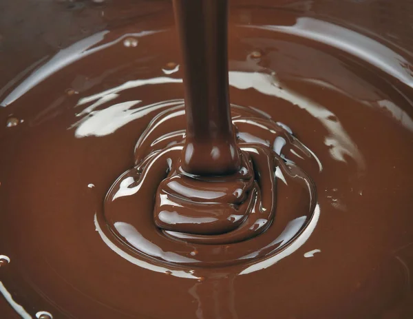 Ots of chocolate falling from above in kitchen — Stock Photo, Image