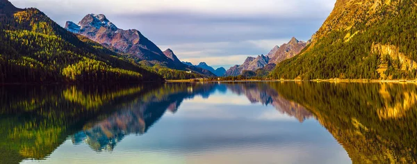 Mountain lake panorama with mountains reflection. Idyllic look. Autumn forest. Silvaplana Lake, Switzerland