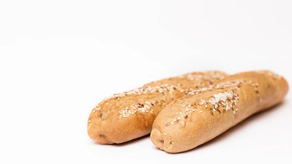 Two French baguette with sesame seeds on a white background — 스톡 사진