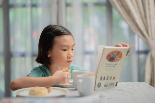 Asian Chinese Child Reading Story Book Breakfast — Stock Photo, Image