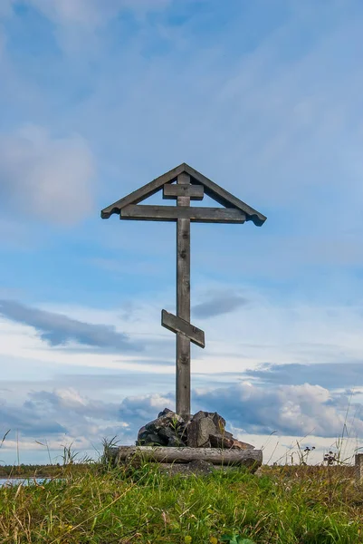 Wooden orthodox cross against a bright sky. Russian worship cross