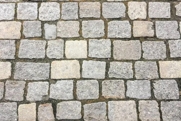 Taş kaldırım dokusu. Granit cobblestoned kaldırım arka plan. Arka plan eski kaldırım taşı kaldırım yakın çekim. Sorunsuz kaldırım doku