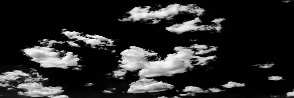 Isolated white clouds on black sky. Set of isolated clouds over black background. Design elements. White isolated clouds. Cutout extracted clouds. Clouds.Black Background.