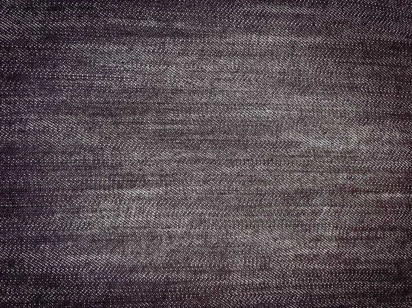 Džín pozadí, textura džíny denim tkanina. Černé pozadí. — Stock fotografie