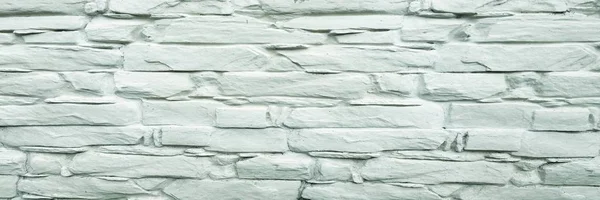 Stone wall background. White painted stone wall texture as background. Rock background wall painting.