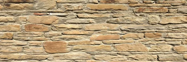 Stacked stone wall background horizontal. White stone tile texture brick wall.