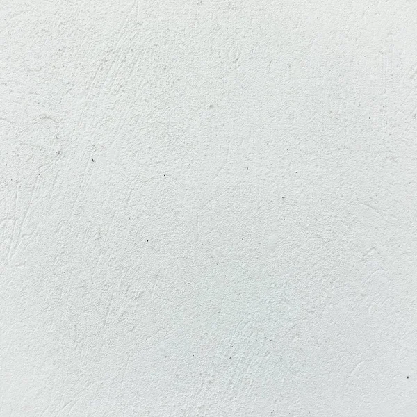 Grunzig bemalte Wandtextur als Hintergrund. Rissiger Betonboden, alt weiß gestrichen. Hintergrund gewaschene Malerei. — Stockfoto