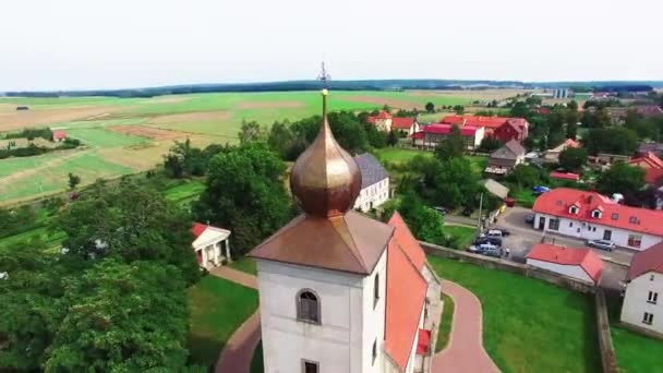 Πύργος της εκκλησίας γύρω από, πυροβολούν εναέρια θέα στο μικρό χωριό — Αρχείο Βίντεο