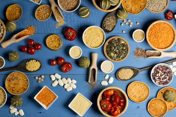 Various Colorful Spices and herbs over rustic wooden background. place for logo