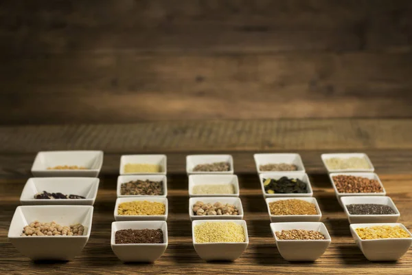 Various Colorful Spices and herbs over rustic wooden background. place for logo
