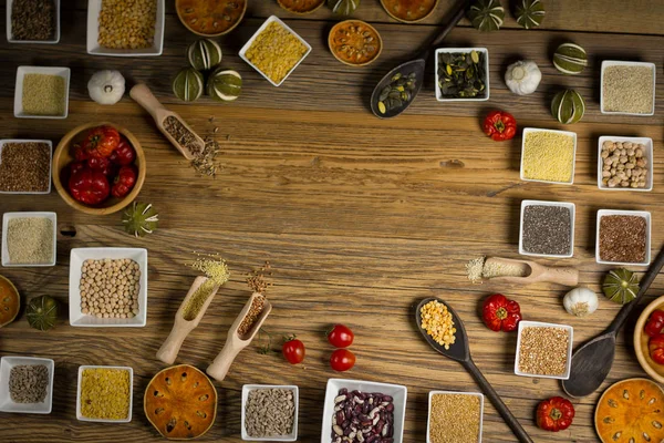 Various Colorful Spices and herbs over rustic wooden background