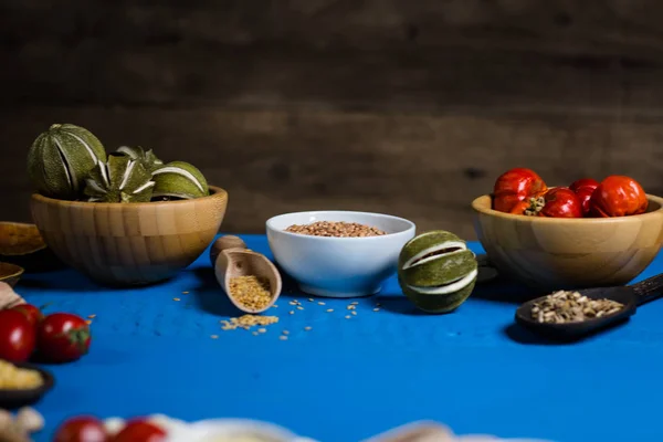 Various Colorful Spices and herbs over rustic wooden background. place for logo