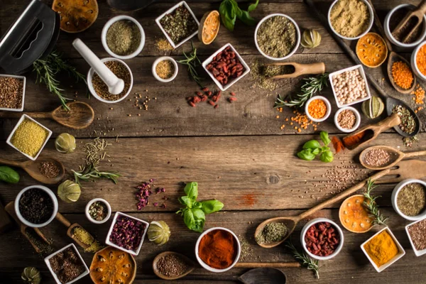 Various colorful spices on wooden table. Place for typography and logo