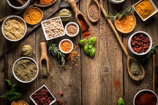 Various colorful spices on wooden table. Place for typography and logo