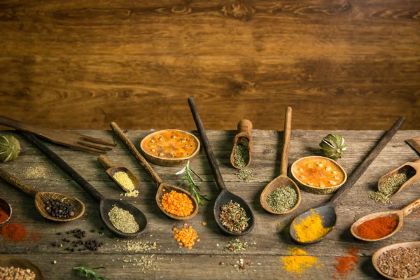 Various colorful spices on wooden table. Place for typography and logo