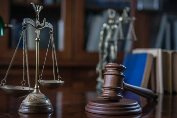 Law concept. Judges mallet with justice scales and books on wooden rustic table, place for typography