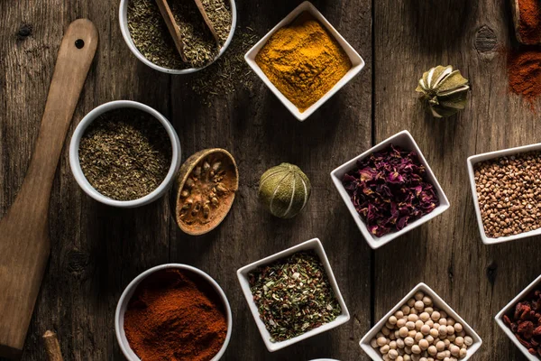 Various colorful spices on wooden table. Place for typography and logo