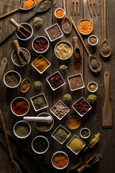 Various colorful spices on wooden table. Place for typography and logo