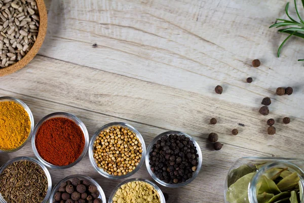 Various colorful spices on wooden table. Place for typography and logo