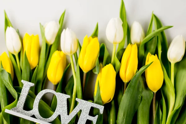 Easter Concept. Easter eggs and tulips on colorful background, place for typography — Stock Photo, Image