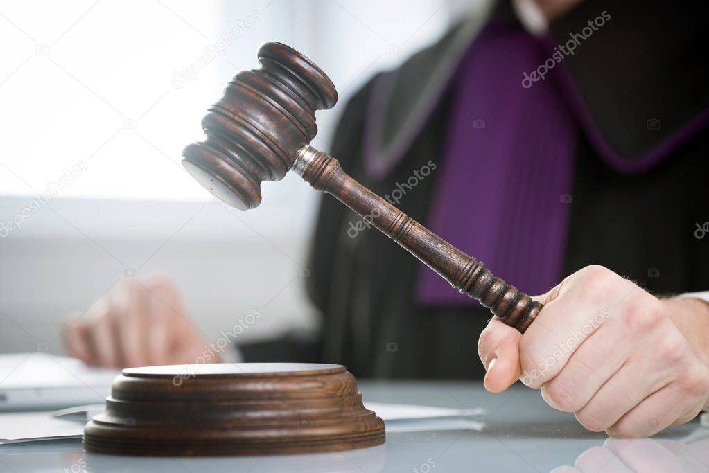 Judge with gavel on table