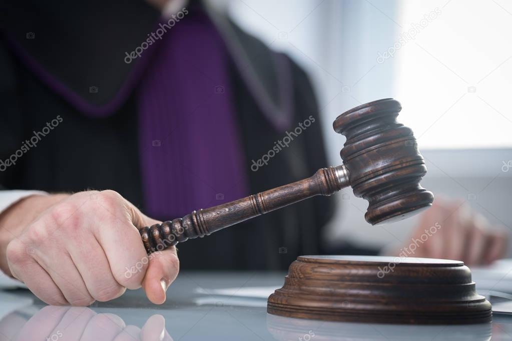 Judge with gavel on table