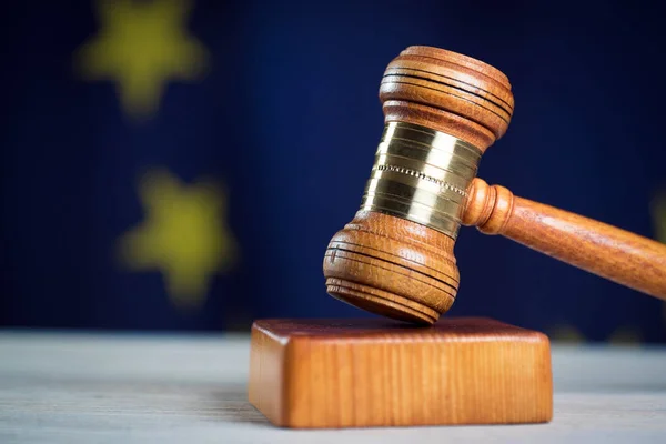 Law concept Gavel and Lady of Justice on wooden table, EU flag