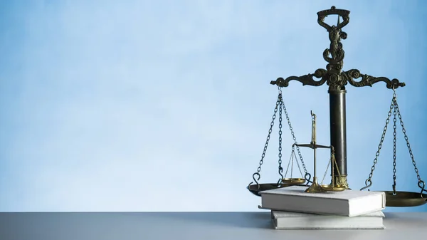 Still life of Law and Justice symbol - scales on wooden table background.