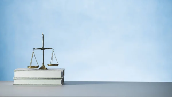 Still life of Law and Justice symbol - scales on wooden table background.