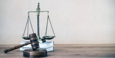 Ahşap masa arkasında hukukun ve adaletin sembolleri