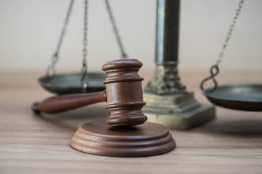 Ahşap masa arkasında hukukun ve adaletin sembolleri