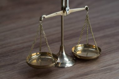 Ahşap masa arkasında adalet terazileri