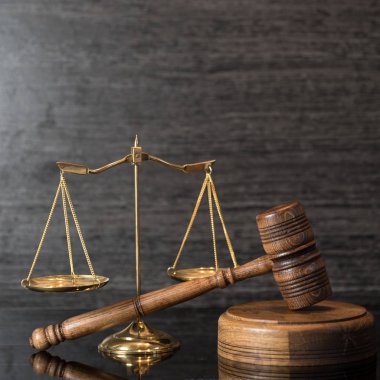 Ahşap masa arkasında hukukun ve adaletin sembolleri